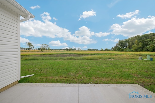 view of yard with a patio and a rural view