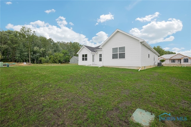 exterior space with a yard and central AC unit