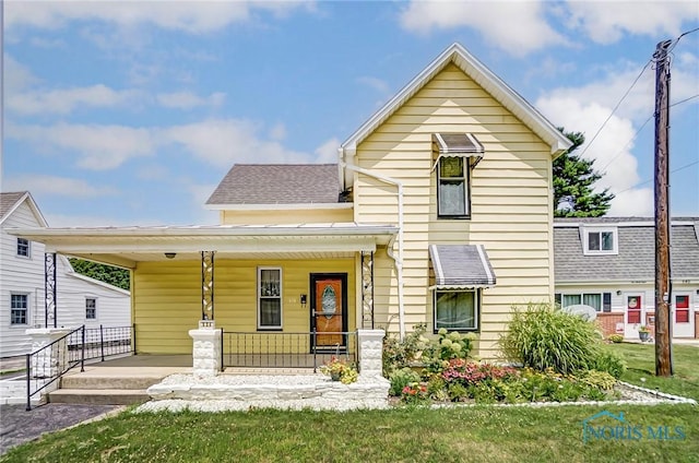 view of front of property with a front yard and a porch