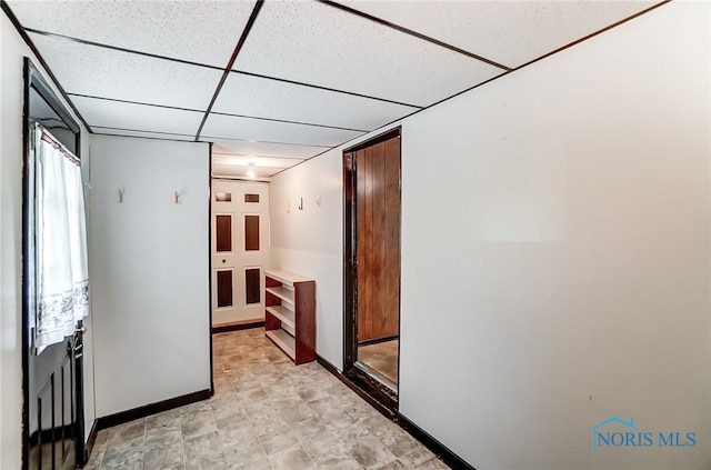 interior space with a paneled ceiling