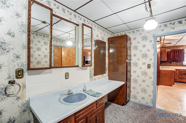 bathroom featuring a drop ceiling and vanity