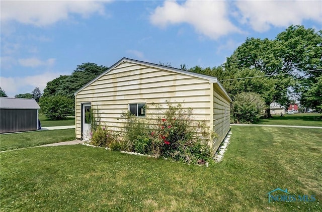 view of outbuilding with a lawn