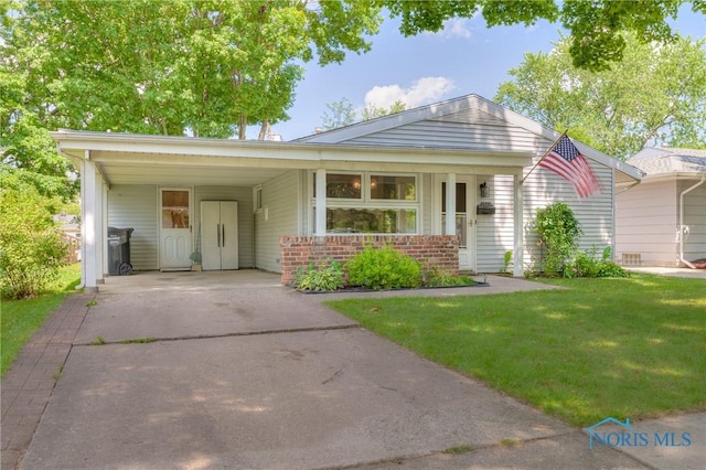 ranch-style home with a front yard and a carport