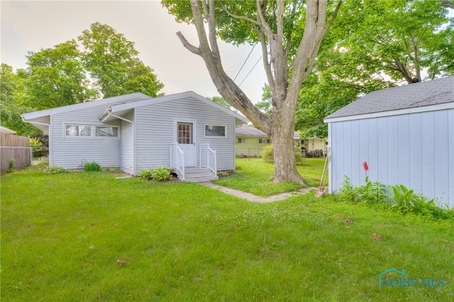 view of outbuilding featuring a yard