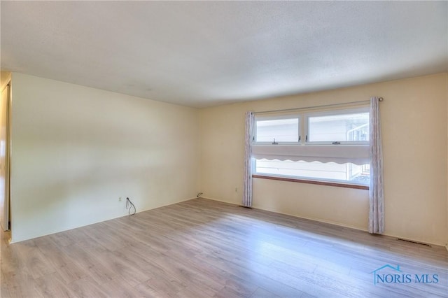 spare room featuring light hardwood / wood-style flooring