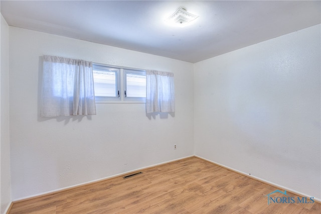 spare room featuring hardwood / wood-style flooring