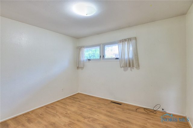 spare room featuring hardwood / wood-style floors