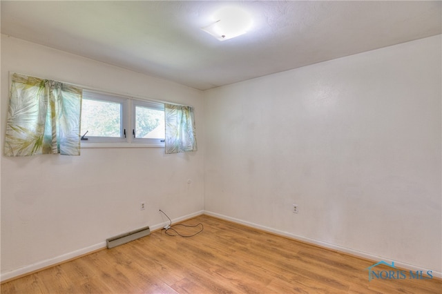 unfurnished room with light hardwood / wood-style floors