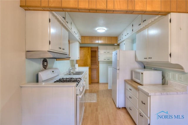 kitchen with sink, light hardwood / wood-style flooring, white cabinets, and white appliances