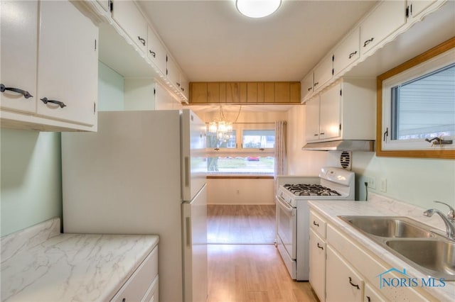 kitchen with white cabinetry, sink, and white appliances