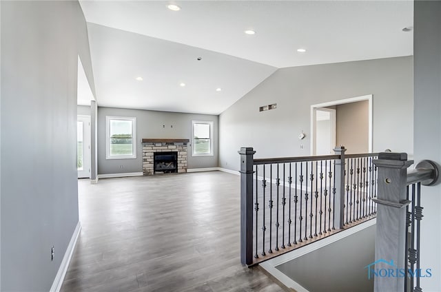 hallway featuring lofted ceiling and hardwood / wood-style floors