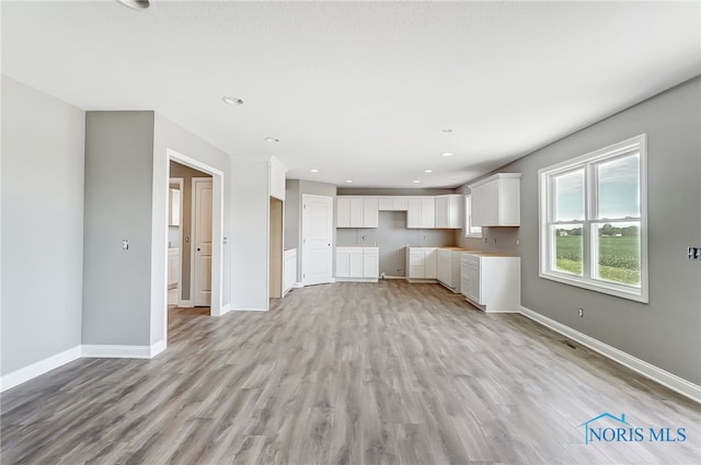 unfurnished living room with light hardwood / wood-style flooring