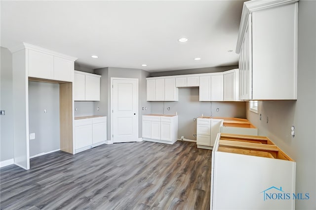 kitchen featuring dark wood-type flooring and white cabinetry