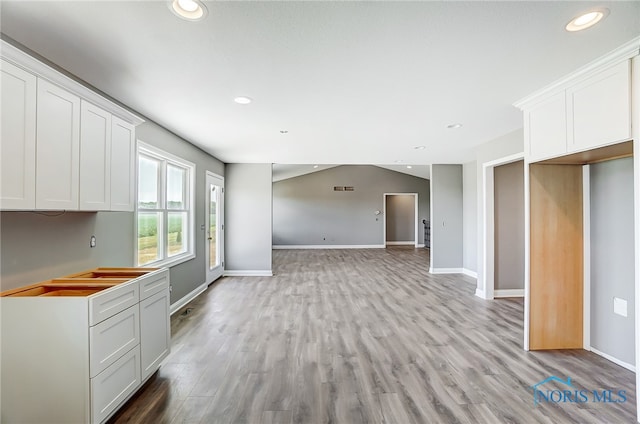 kitchen featuring light wood-type flooring and white cabinets