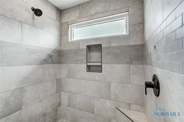 bathroom featuring tiled shower