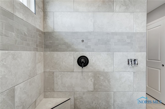 bathroom with a tile shower