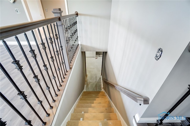 stairway with wood-type flooring