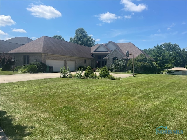 view of front of property with a garage and a front lawn