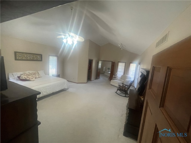 bedroom with carpet flooring, vaulted ceiling, multiple windows, and ceiling fan