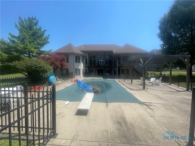 view of pool with a pergola and a patio