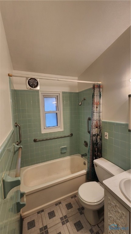 full bathroom with toilet, tile walls, shower / bath combination with curtain, and vanity