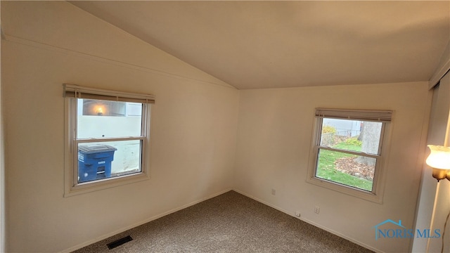 unfurnished room with carpet floors and lofted ceiling