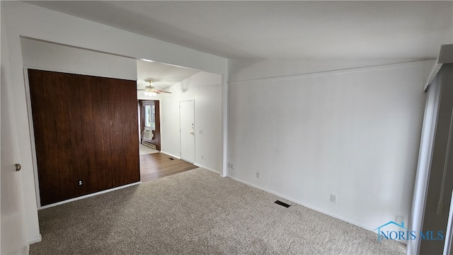 carpeted empty room featuring lofted ceiling