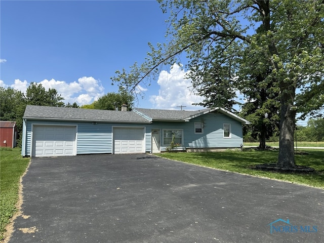 view of front of home featuring a garage and a front lawn