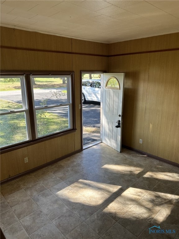 unfurnished room with wood walls