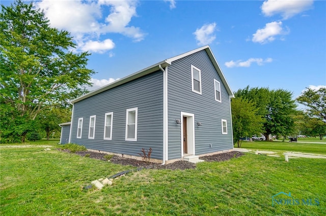 view of property exterior with a lawn