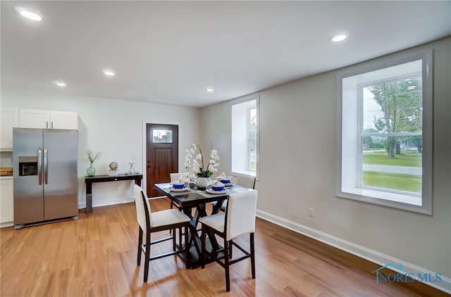 dining space with light wood-type flooring