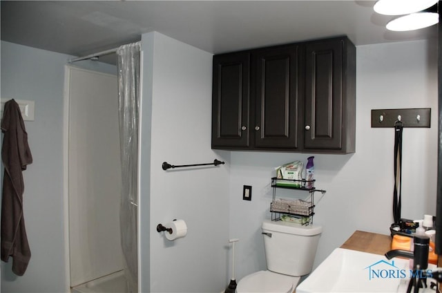 bathroom featuring vanity, toilet, and walk in shower