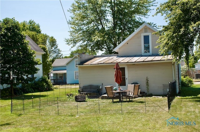 rear view of house with a lawn