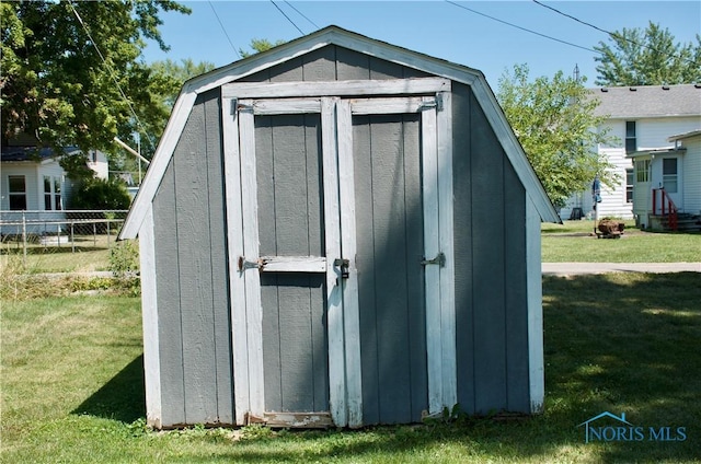 view of outbuilding with a yard