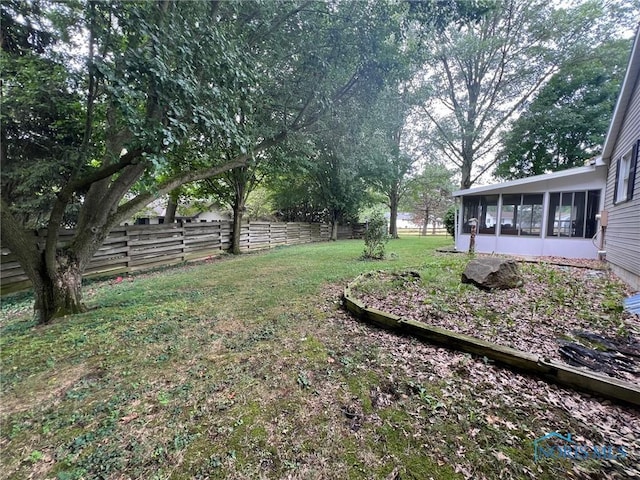 view of yard featuring a sunroom