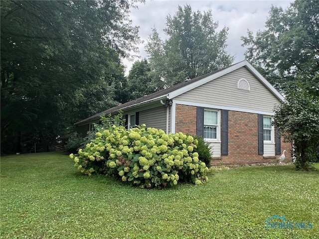 view of side of home featuring a yard