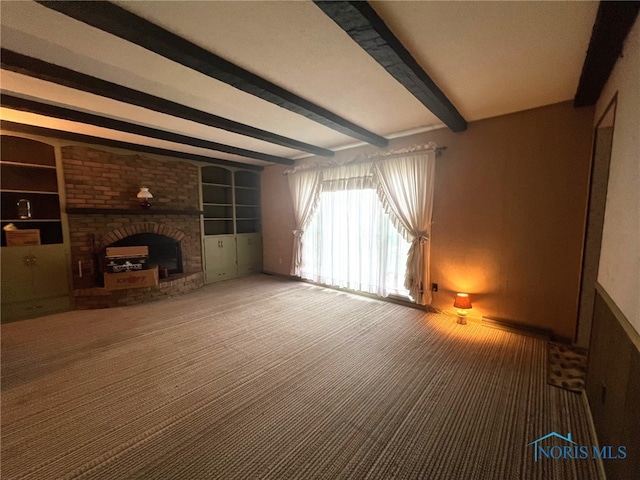 unfurnished living room with a brick fireplace, beam ceiling, built in features, and carpet