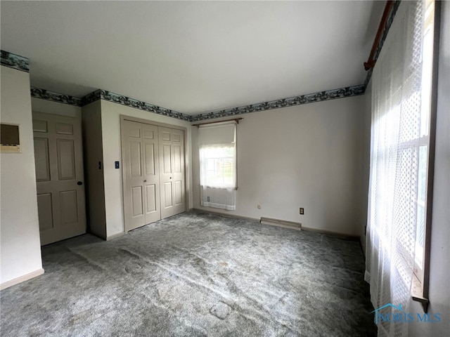 unfurnished bedroom with carpet floors and a closet