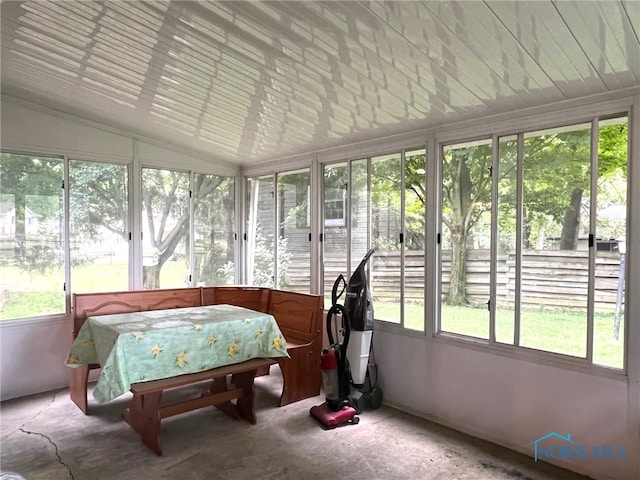 sunroom / solarium featuring lofted ceiling