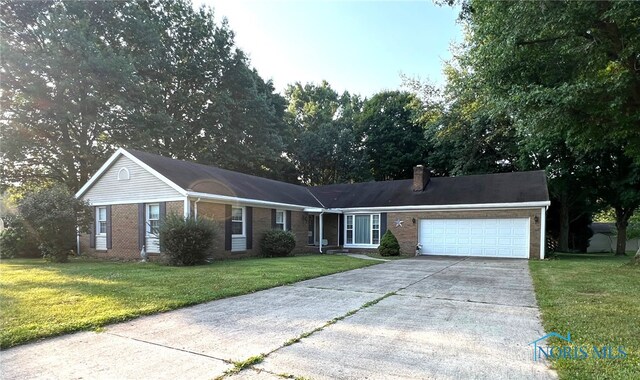 ranch-style house featuring a garage and a front yard