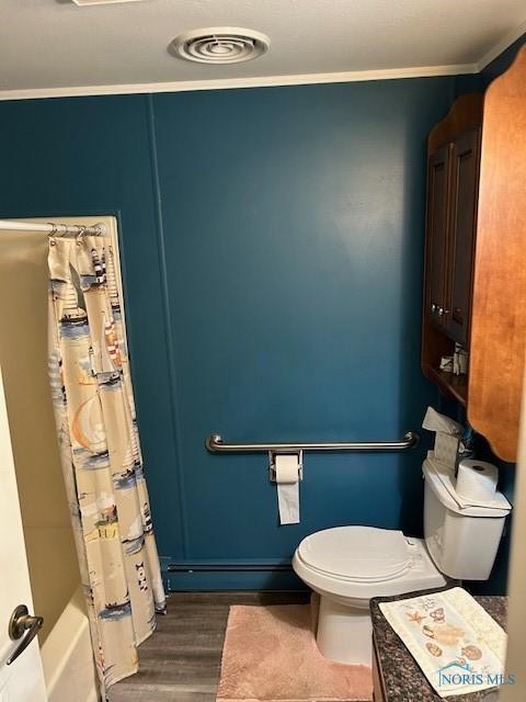 bathroom featuring shower / bathtub combination with curtain, hardwood / wood-style flooring, crown molding, baseboard heating, and toilet