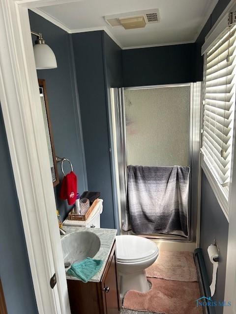 bathroom with vanity, an enclosed shower, crown molding, and toilet