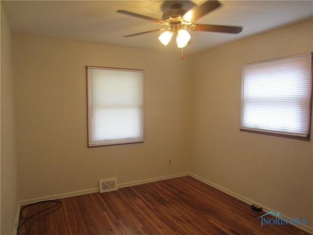 unfurnished room featuring dark hardwood / wood-style floors and ceiling fan