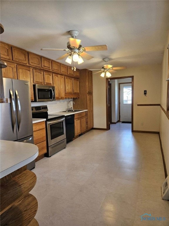 kitchen with ceiling fan, sink, and stainless steel appliances