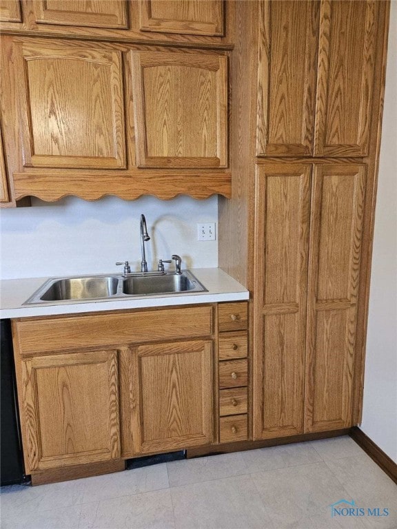 kitchen featuring light tile patterned floors and sink