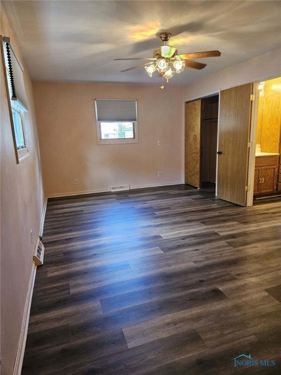 unfurnished bedroom featuring ceiling fan, dark wood-type flooring, and a closet