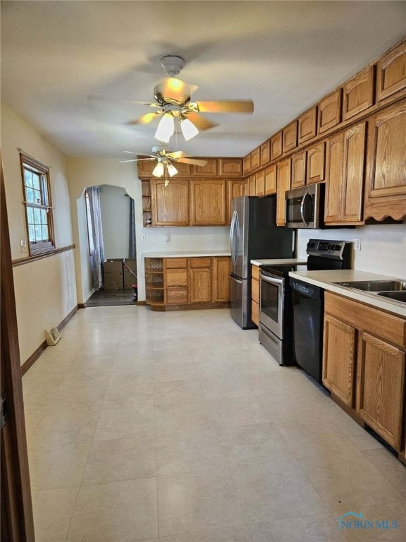 kitchen with ceiling fan, sink, and appliances with stainless steel finishes