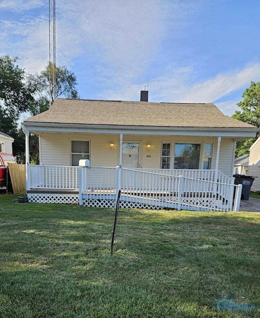 view of front of property with covered porch and a front yard