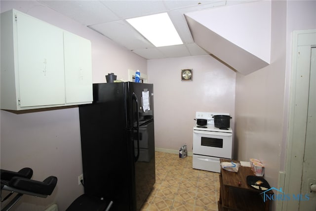 kitchen featuring electric range, black refrigerator, light tile patterned floors, and a paneled ceiling