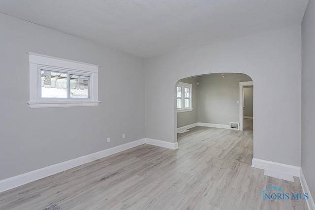 empty room with light hardwood / wood-style flooring